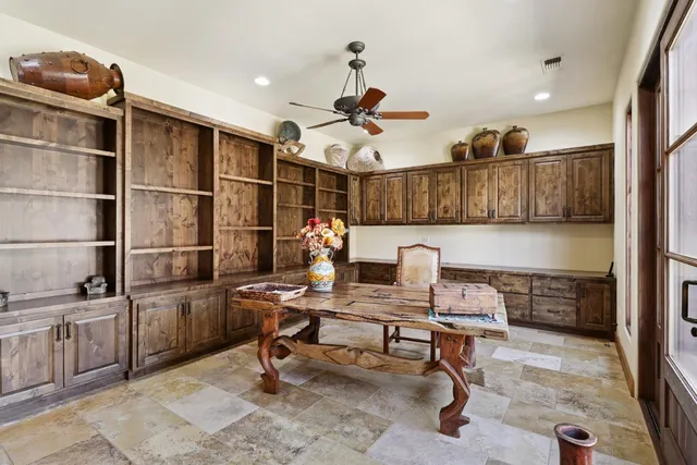 a view of a patio with table and chairs potted plants and large tree
