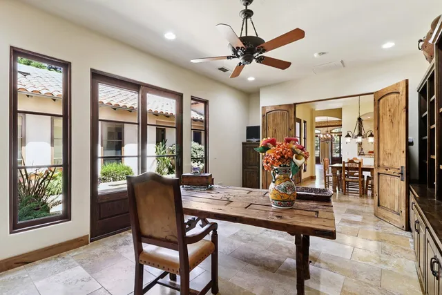 a view of a patio with table and chairs potted plants with large tree