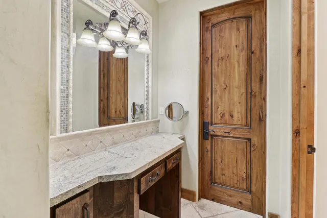 a view of a street with a yard and a large tree