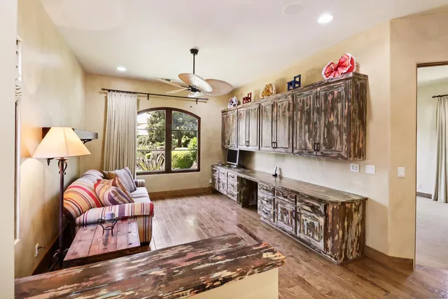 an aerial view of a house with swimming pool and large trees