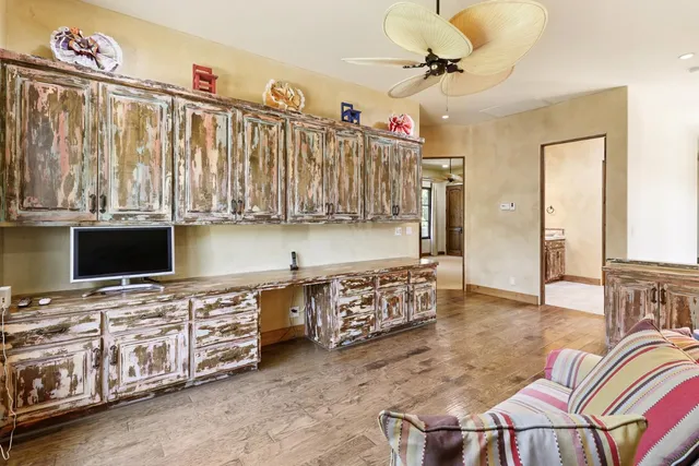 an aerial view of a house with a yard and a large tree