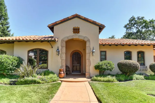 a front view of a house with garden