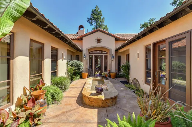 a living room with fireplace furniture and a chandelier