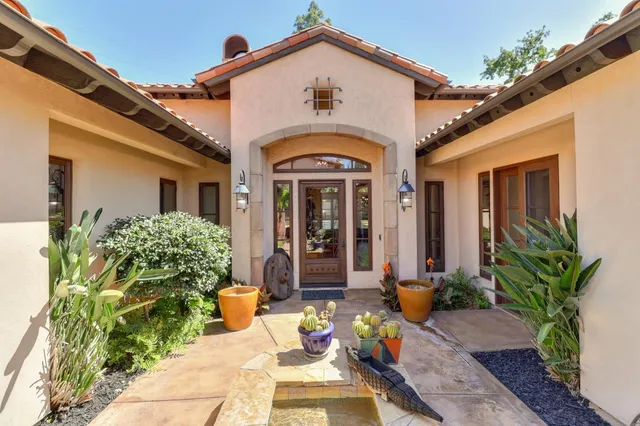 a living room with furniture a ceiling fan and a rug