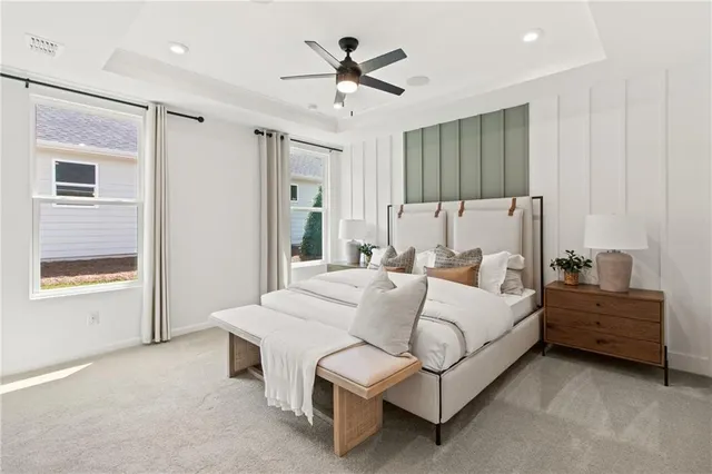 a bedroom with a bed and a painting on the wall