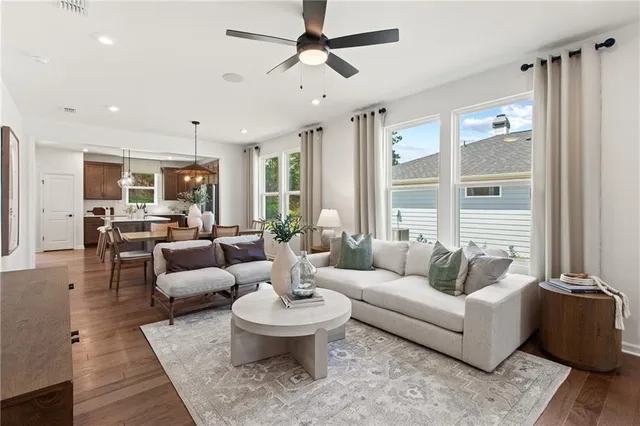 a living room with furniture a rug and a flat screen tv