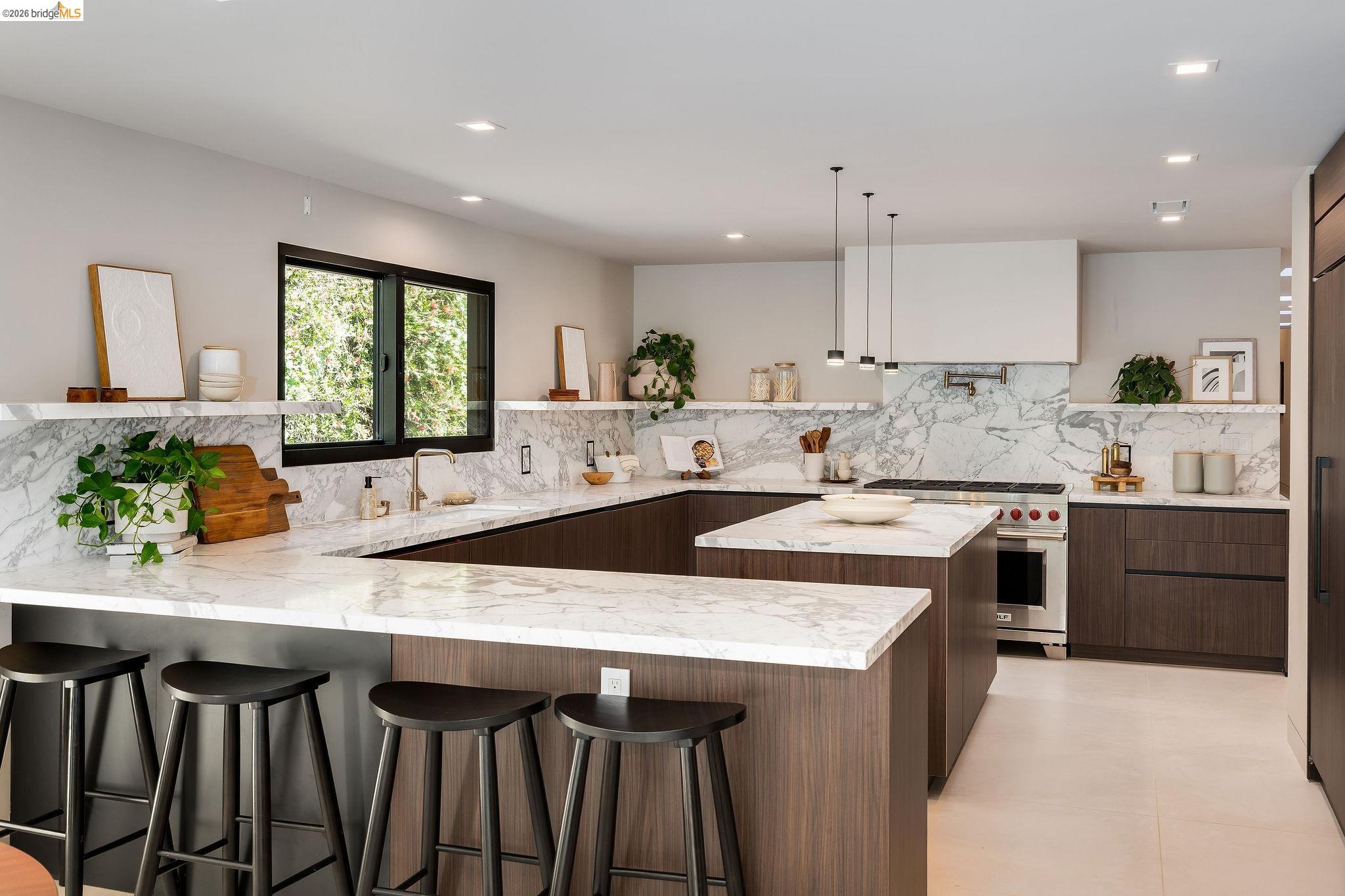 5645 Bacon Road Oakland, CA 94619 - Photo 36 of 94 Modern kitchen featuring dark wood-finish cabinetry, white stone countertops, and a full-height stone backsplash
