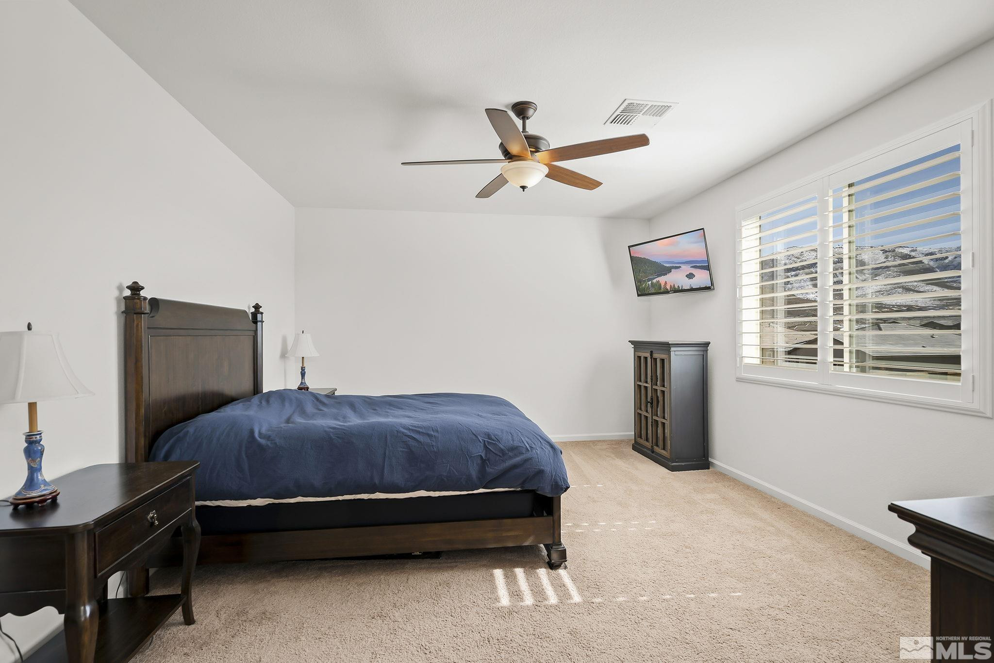 2860 Bonfire Lane Reno, NV 89521 - Photo 13 of 25 a bedroom with a bed and a flat screen tv