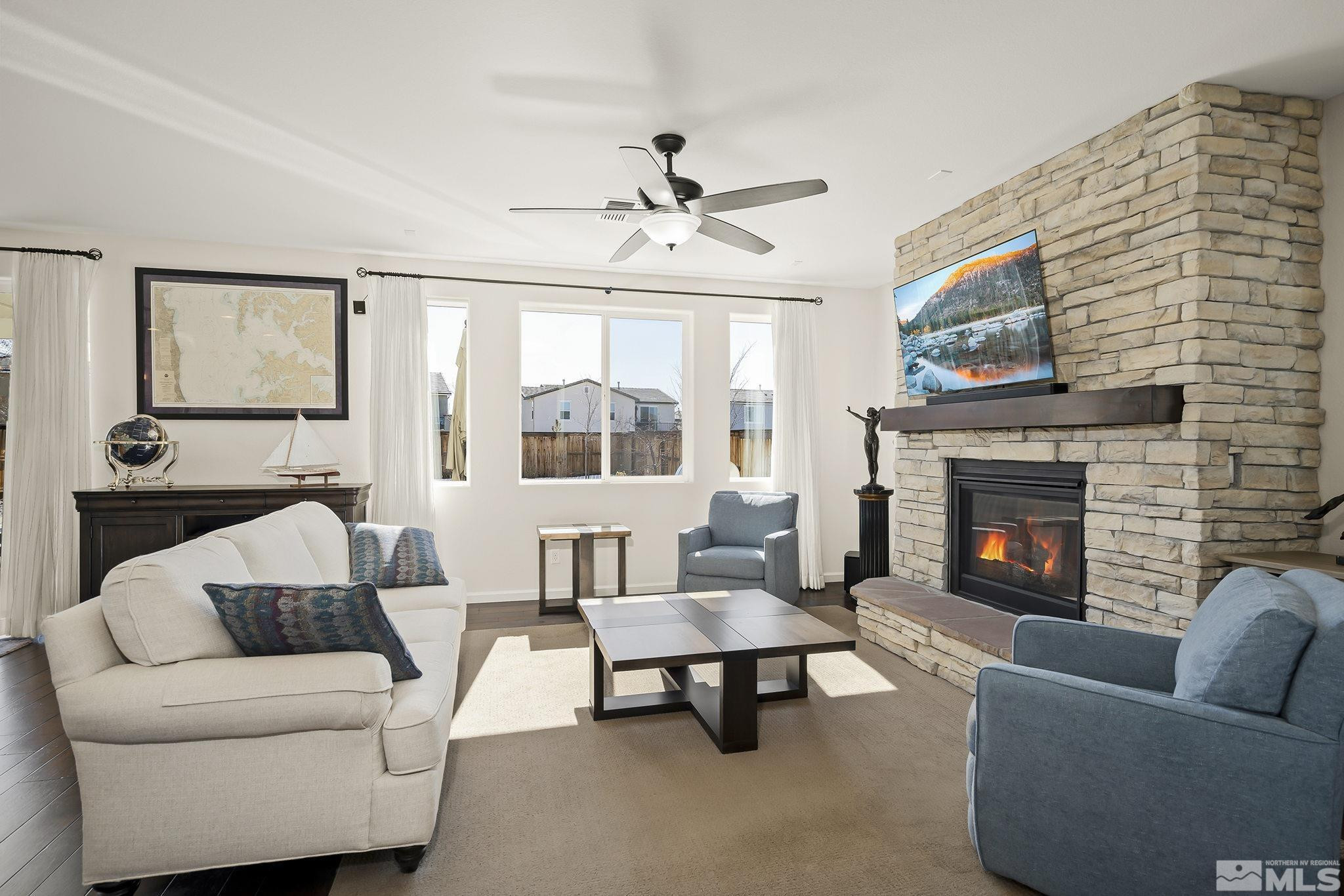 2860 Bonfire Lane Reno, NV 89521 - Photo 3 of 25 a living room with furniture a rug and a fireplace