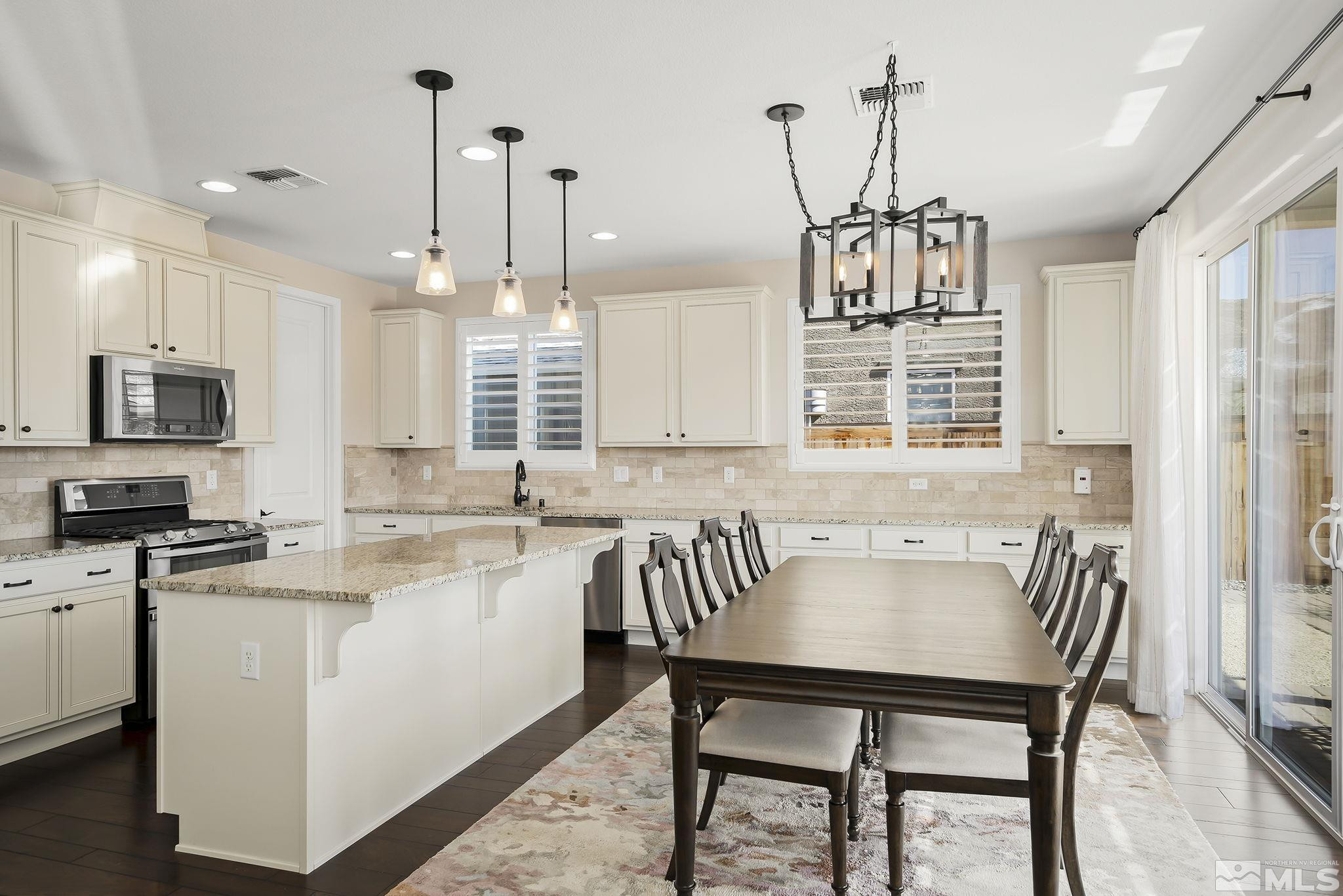 2860 Bonfire Lane Reno, NV 89521 - Photo 7 of 25 a kitchen with a table chairs microwave and cabinets
