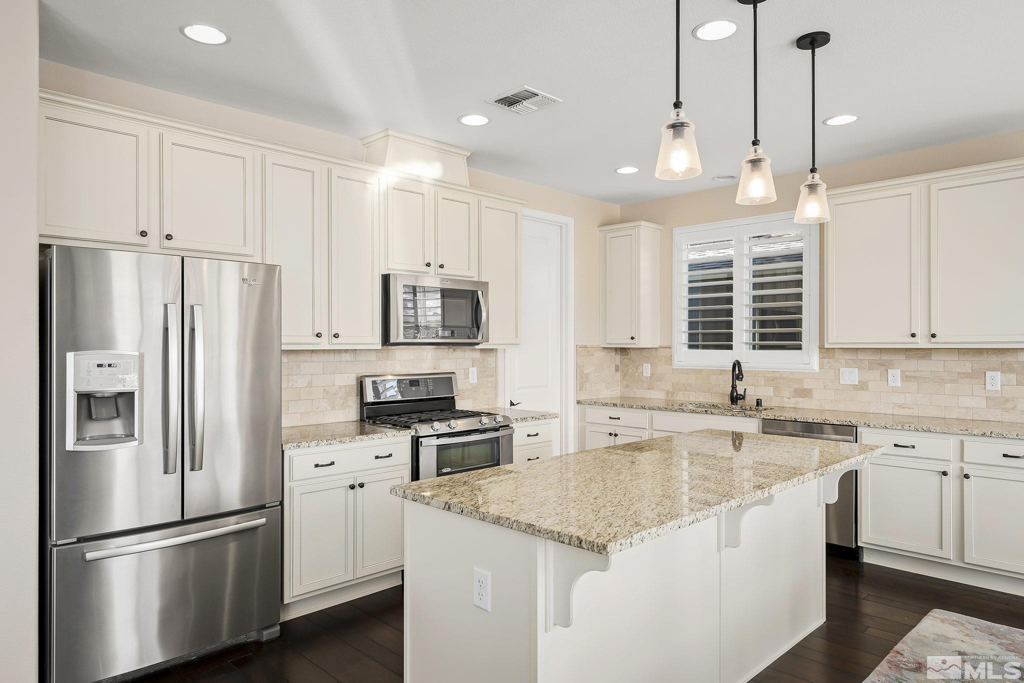2860 Bonfire Lane Reno, NV 89521 - Photo 9 of 25 a kitchen with stainless steel appliances granite countertop a sink stove and refrigerator