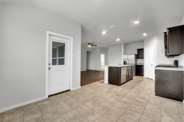 a large white kitchen with cabinets