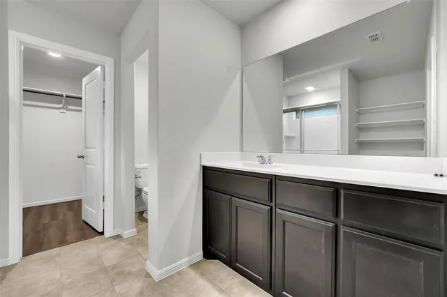 a bathroom with a double vanity sink and mirror
