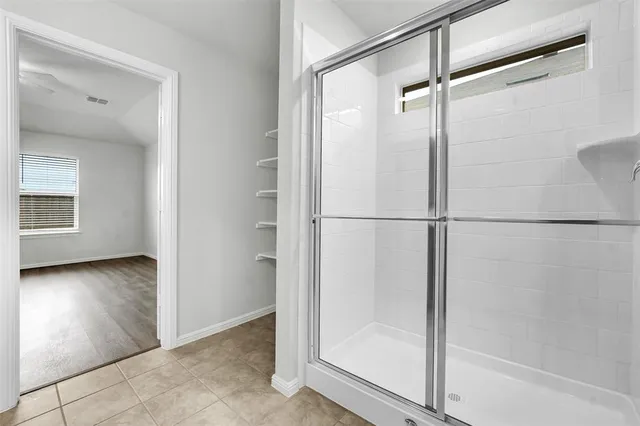 a bathroom with a glass shower door