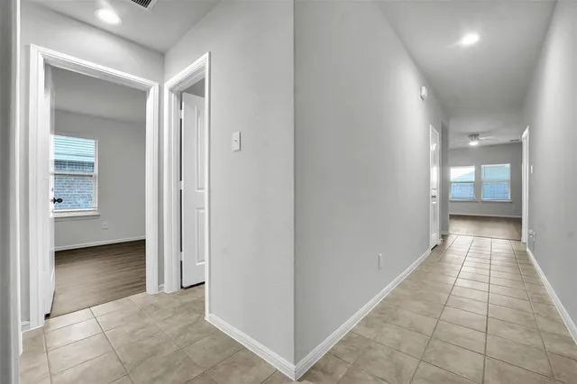 a view of a hallway with a furniture and a bathroom