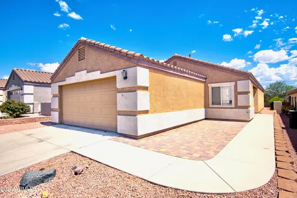 a view of a house with a backyard