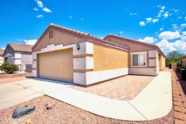 a view of a house with a backyard