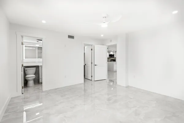 an empty room with a fireplace and cabinet