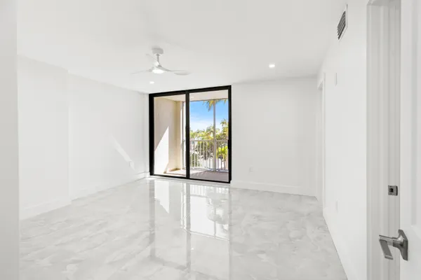 an empty room with windows and closet