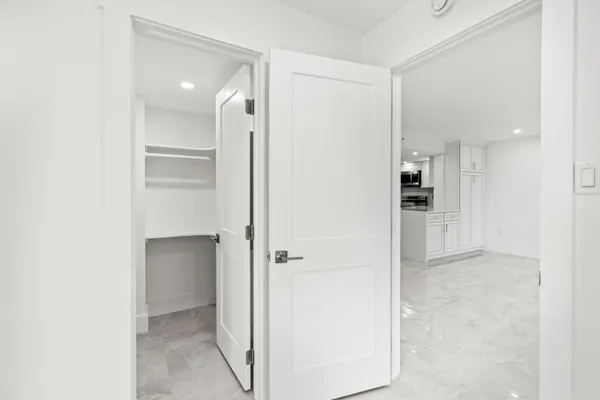 a view of a kitchen with a refrigerator and a sink