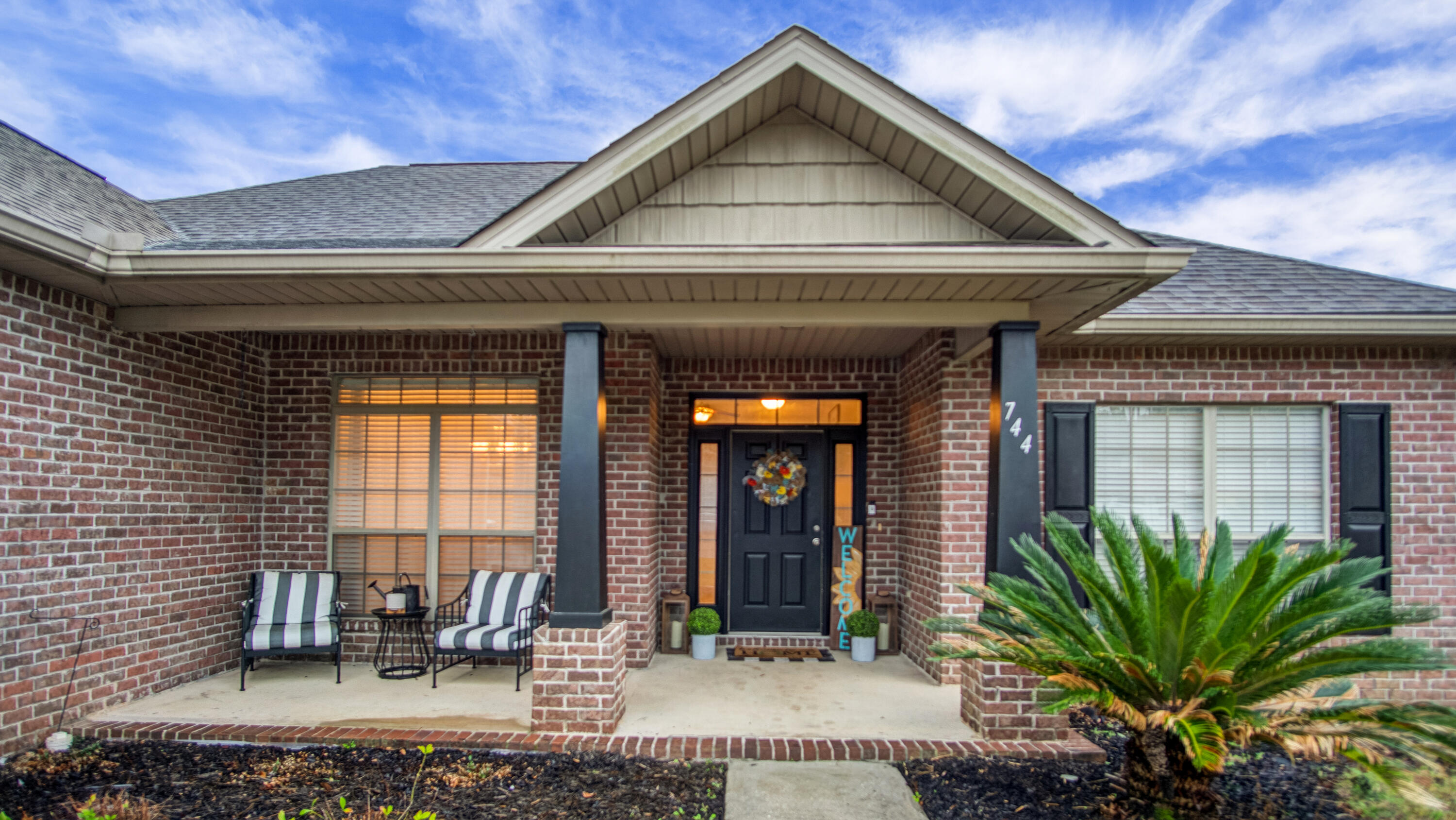 a front view of a house with garden