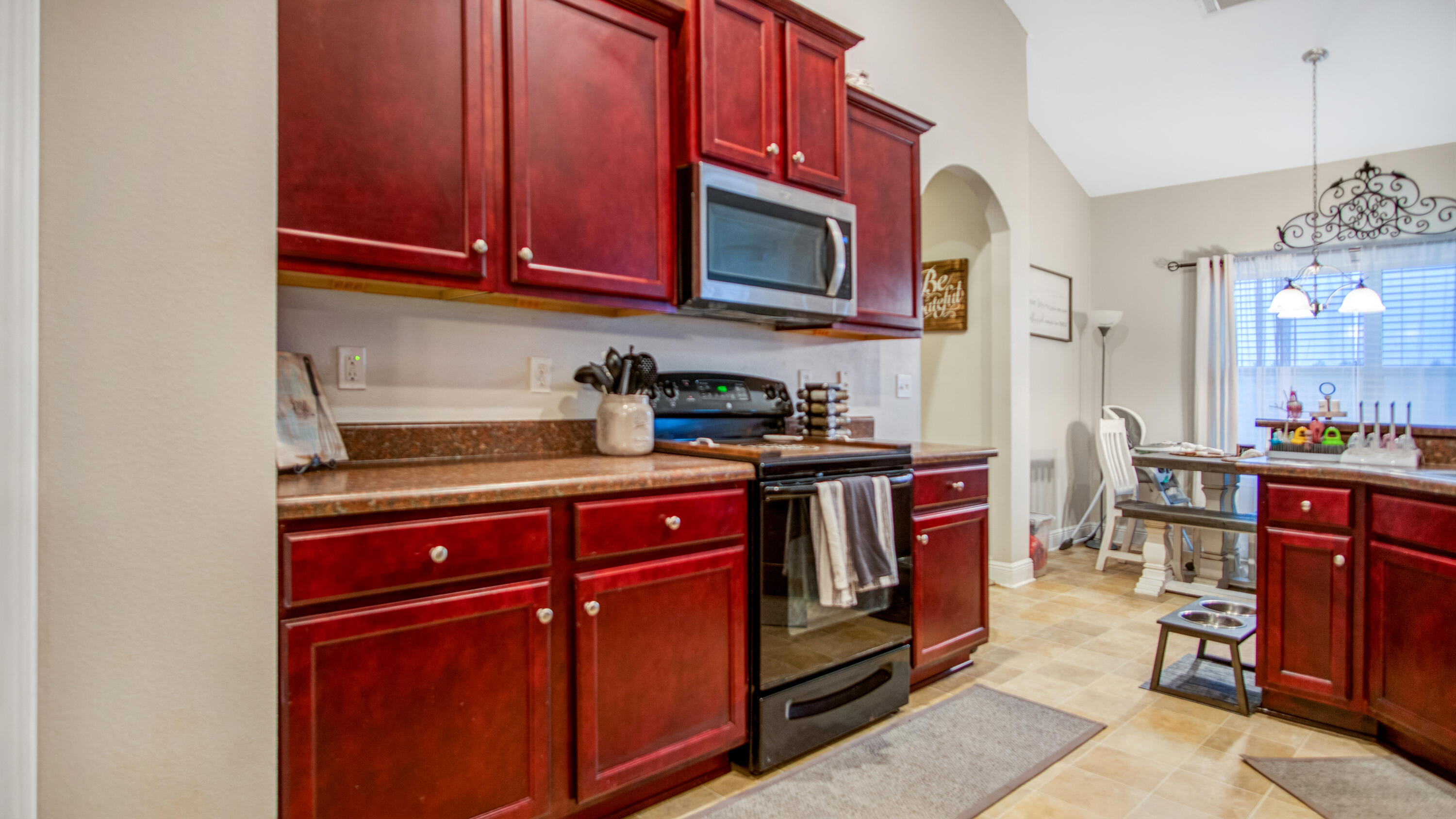 744 Lime Lane Crestview, FL 32536 - Photo 20 of 33 a kitchen with stainless steel appliances granite countertop a refrigerator and wooden cabinets