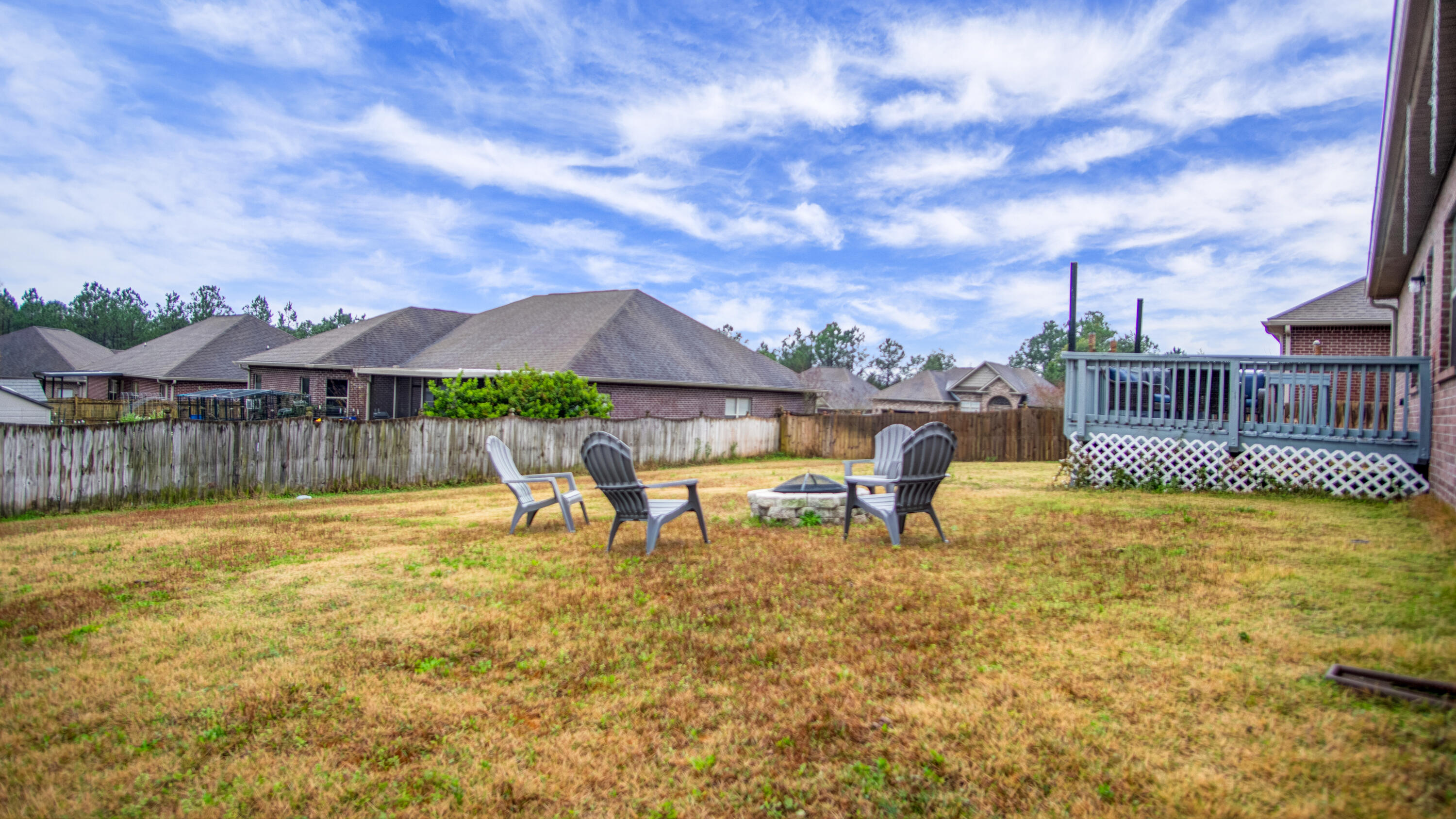 744 Lime Lane Crestview, FL 32536 - Photo 29 of 33 a view of a swimming pool with lawn chairs and iron fence