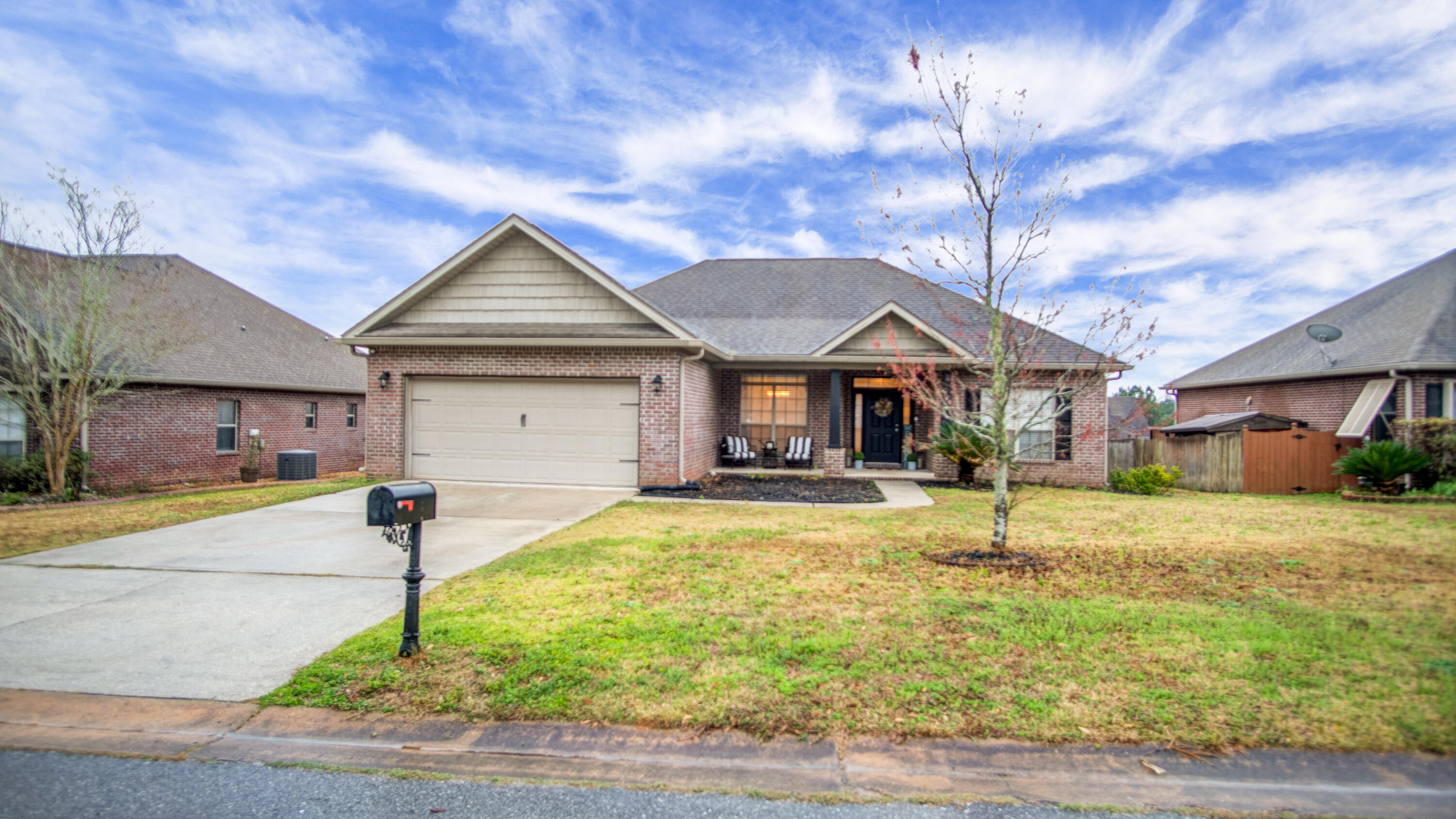 744 Lime Lane Crestview, FL 32536 - Photo 3 of 33 a front view of a house with a yard fountain and garage