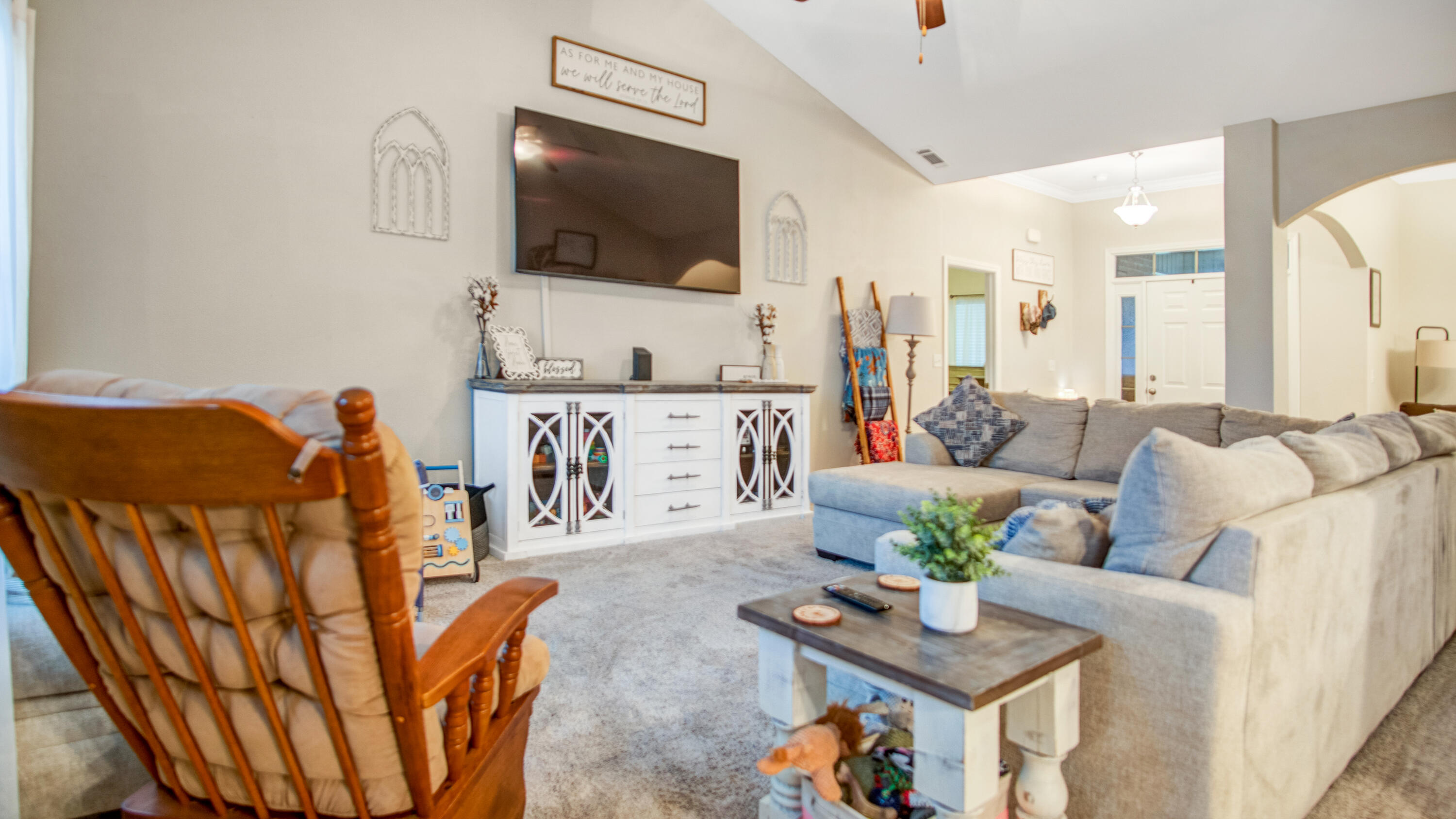 744 Lime Lane Crestview, FL 32536 - Photo 10 of 33 a living room with furniture a flat screen tv and kitchen view
