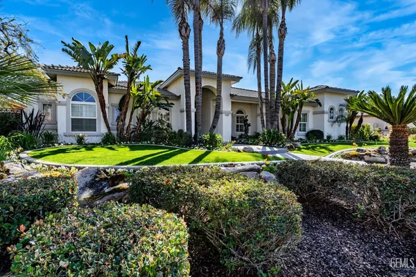 a kitchen with stainless steel appliances kitchen island granite countertop a sink and cabinets