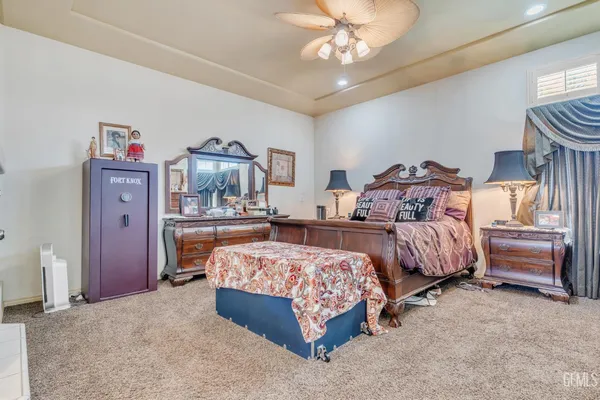 a bedroom with bed and a chandelier