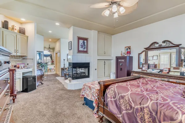 a living room with furniture a bookshelf and a window