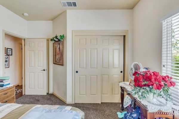 a living room with furniture a chandelier and a window