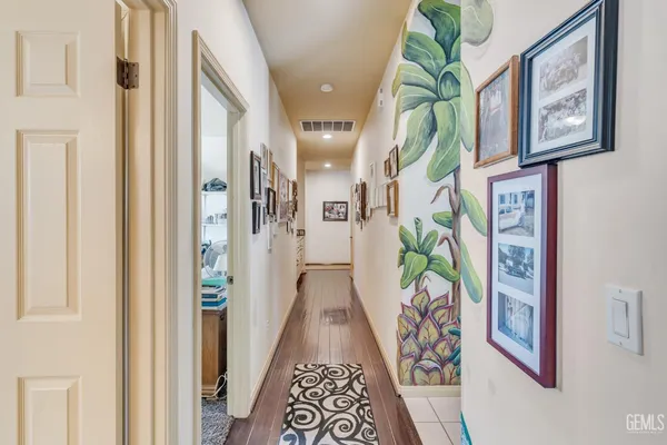 a front view of a house with garden and trees
