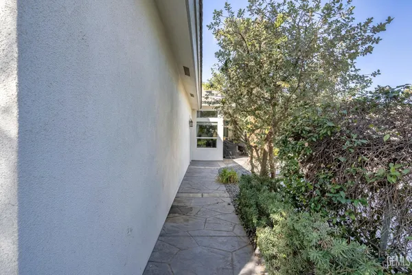 a view of a house with swimming pool and a small yard