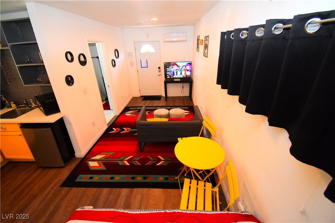 308 North 10th Street, Unit B Las Vegas, NV 89101 - Photo 2 of 17 Playroom featuring wood finished floors, a wall mo
