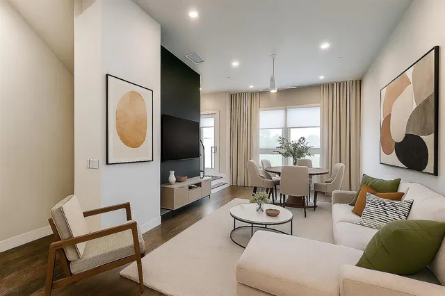 a view of a kitchen with wooden floor and a window