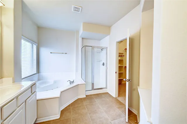 a bathroom with a tub sink and mirror