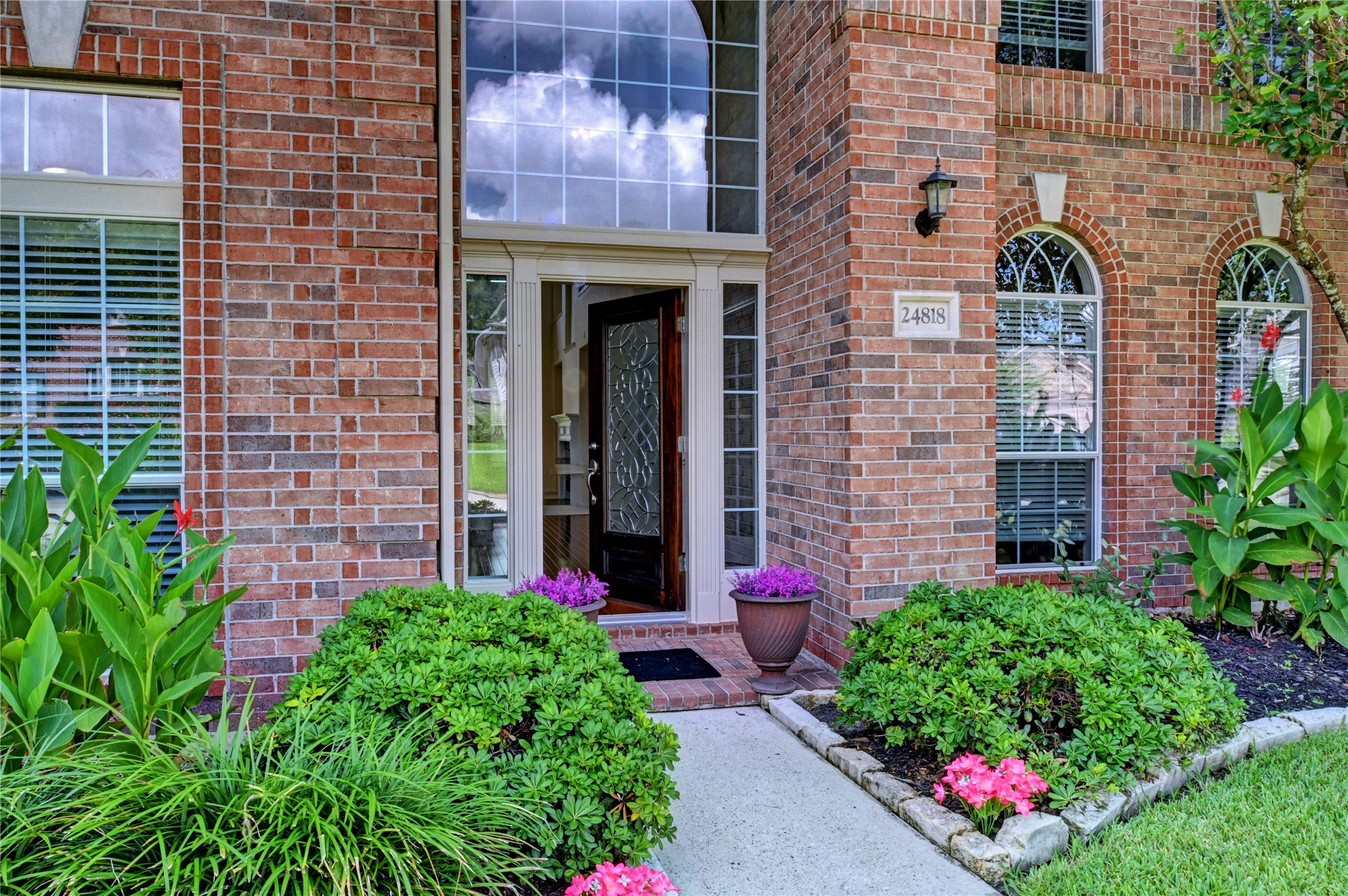 24818 Corbin Gate Drive Spring, TX 77389 - Photo 4 of 49 a bunch of flowers in front of brick building