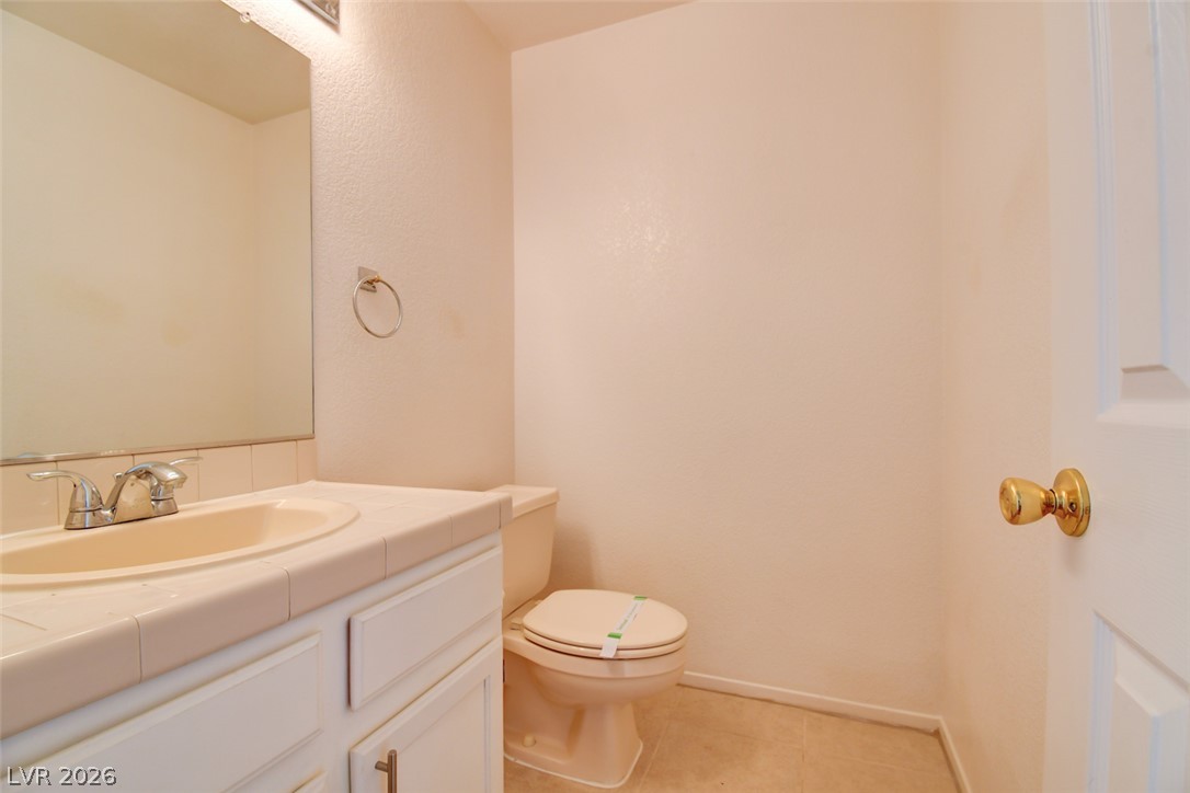 5 Tarryall Terrace Henderson, NV 89074 - Photo 9 of 44 A well-maintained powder room with a vanity sink and toilet.