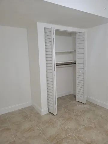 a room with a sink and cabinets
