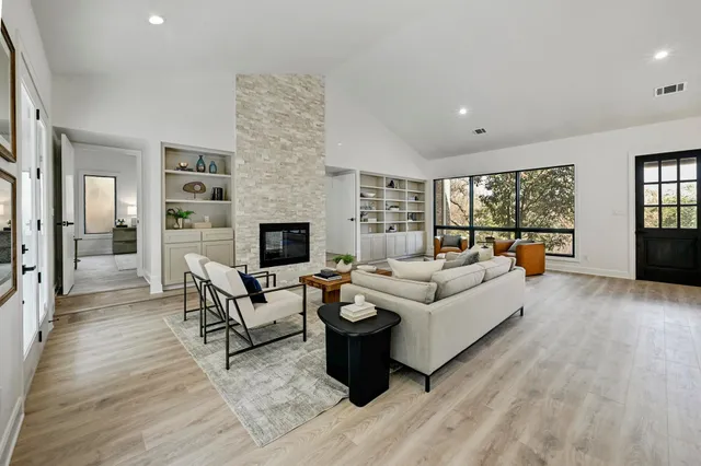 a living room with furniture wooden floor and a fireplace