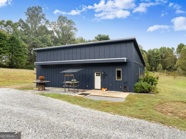 a view of a house with backyard and sitting area