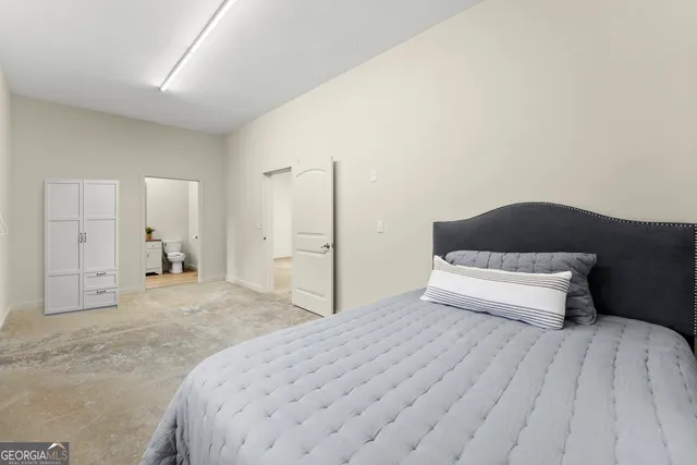 a bedroom with a bed and a lamp