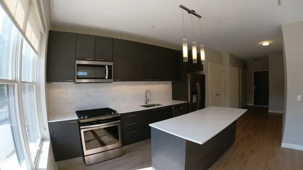 a kitchen that has a sink and a stove top oven