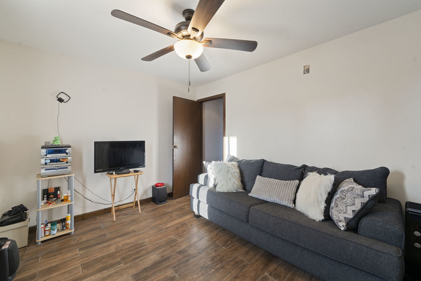 756 Rodenburg Road, Unit 1C Roselle, IL 60172 - Photo 14 of 28 a living room with furniture and a flat screen tv