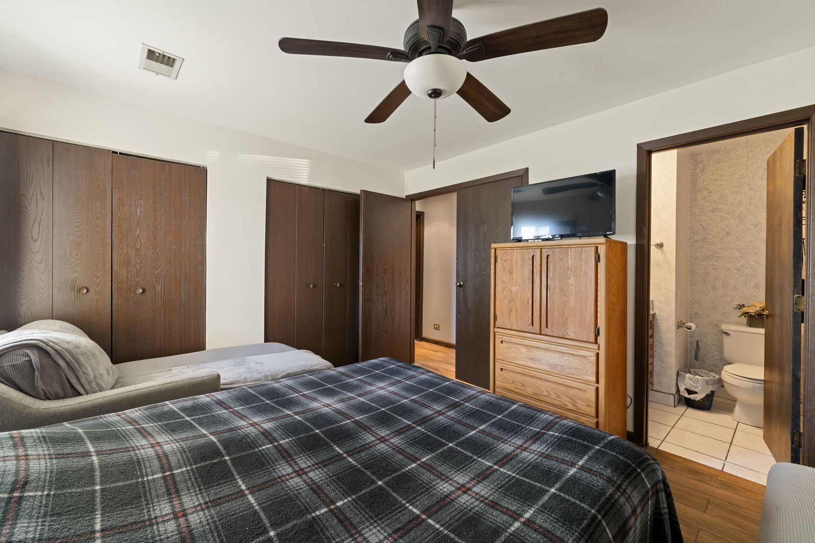 756 Rodenburg Road, Unit 1C Roselle, IL 60172 - Photo 17 of 28 a bedroom with bed and wooden floor