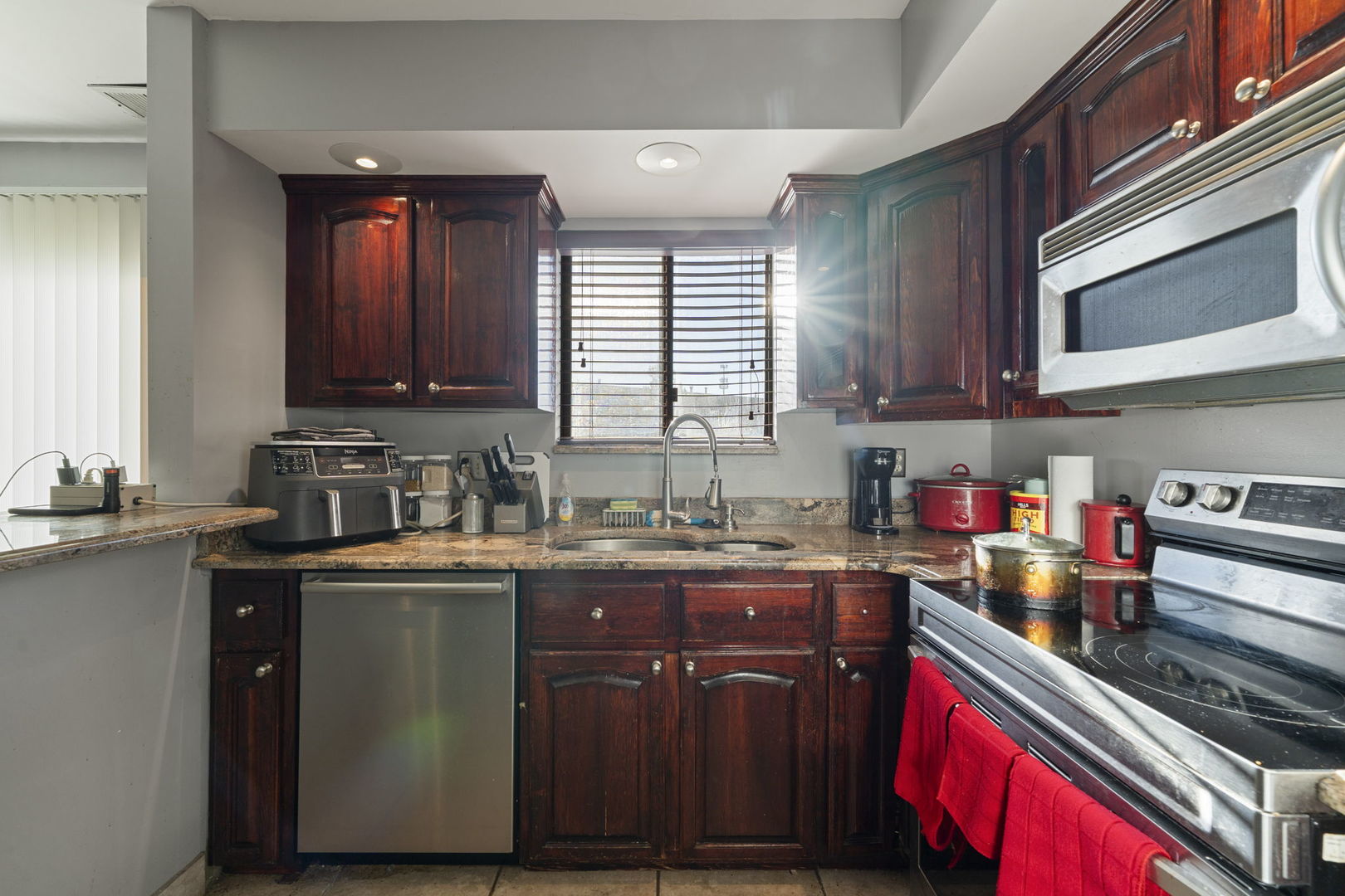 756 Rodenburg Road, Unit 1C Roselle, IL 60172 - Photo 4 of 28 a kitchen with stainless steel appliances granite countertop a sink stove and cabinets