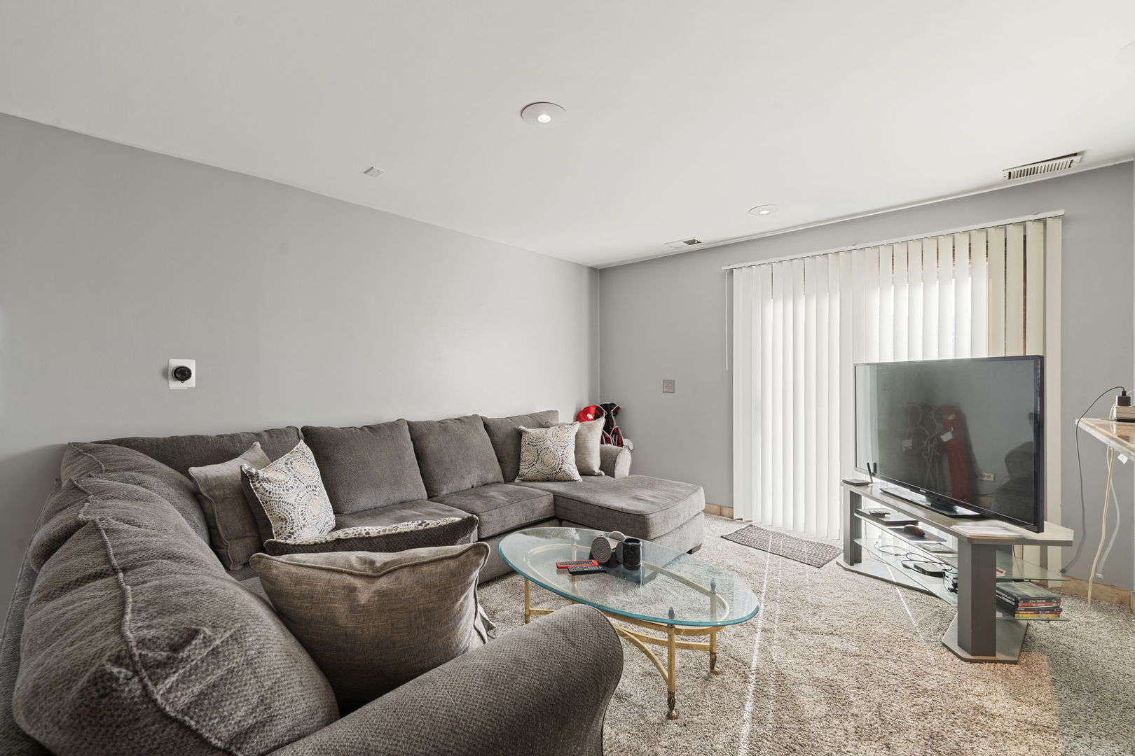 756 Rodenburg Road, Unit 1C Roselle, IL 60172 - Photo 7 of 28 a living room with furniture and a flat screen tv