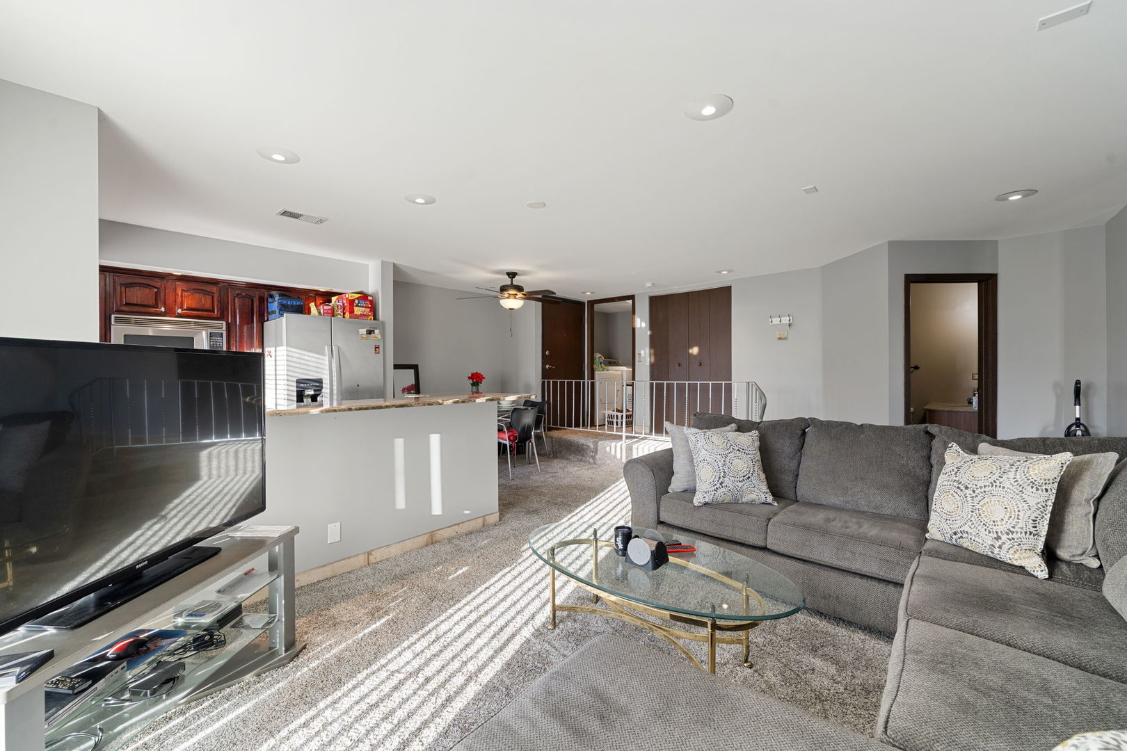 756 Rodenburg Road, Unit 1C Roselle, IL 60172 - Photo 9 of 28 a living room with furniture and a flat screen tv
